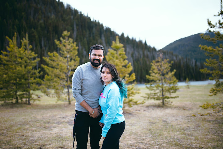 Couple together beside a mountain lake