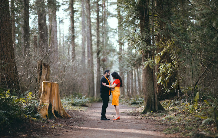 Expectant couple on a forest trail