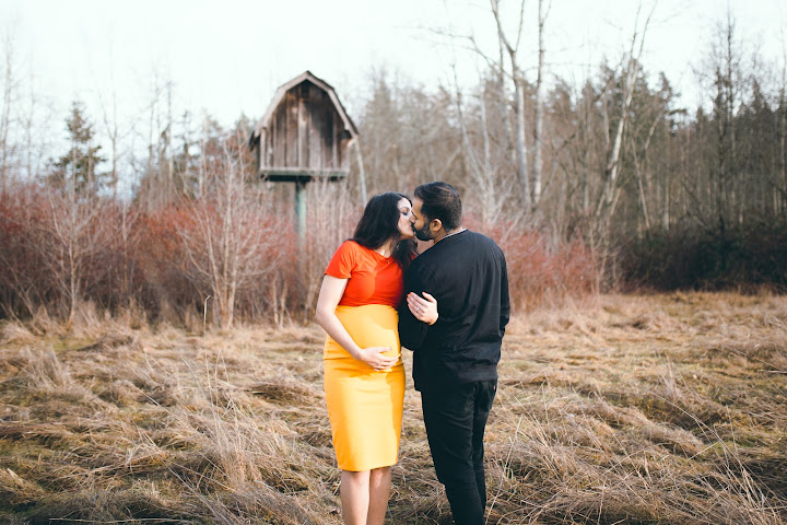 Expectant couple sharing a moment outdoors