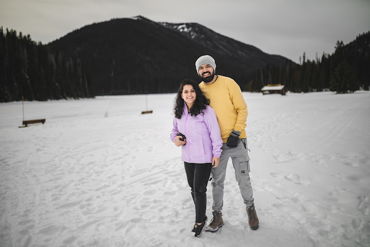Couple standing together in a snowy mountain landscape