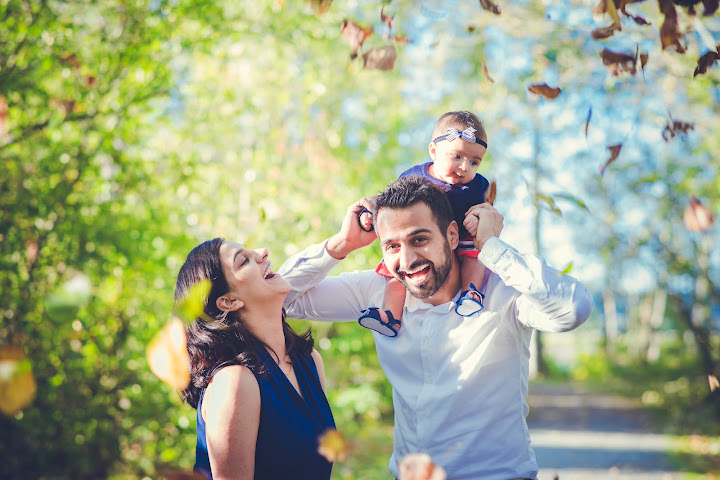 Family enjoying a sunny day beneath the trees