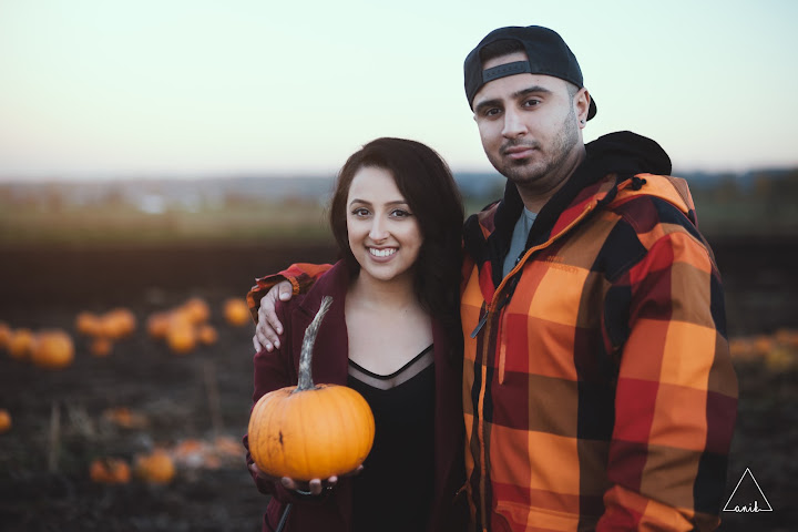 Couple holding a pumpkin together