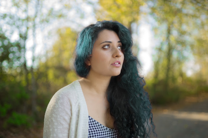 Portrait beneath sunlit trees