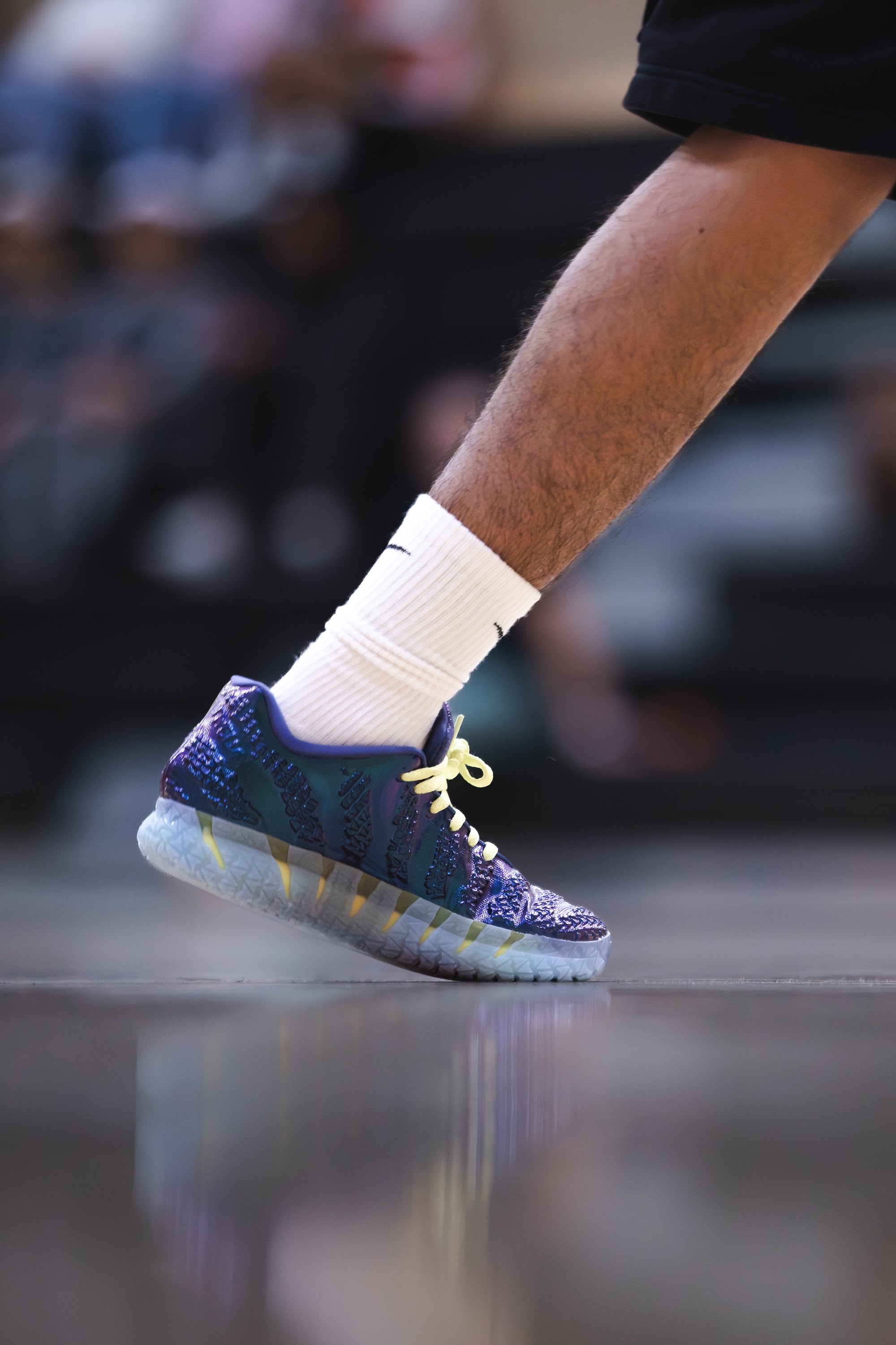 Close-up of a colourful basketball shoe lifting from the gym floor