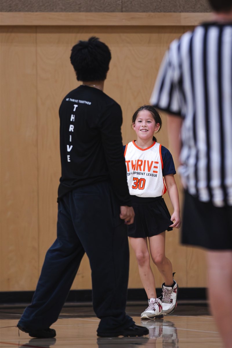 Basketball player speaking with a coach near the sideline