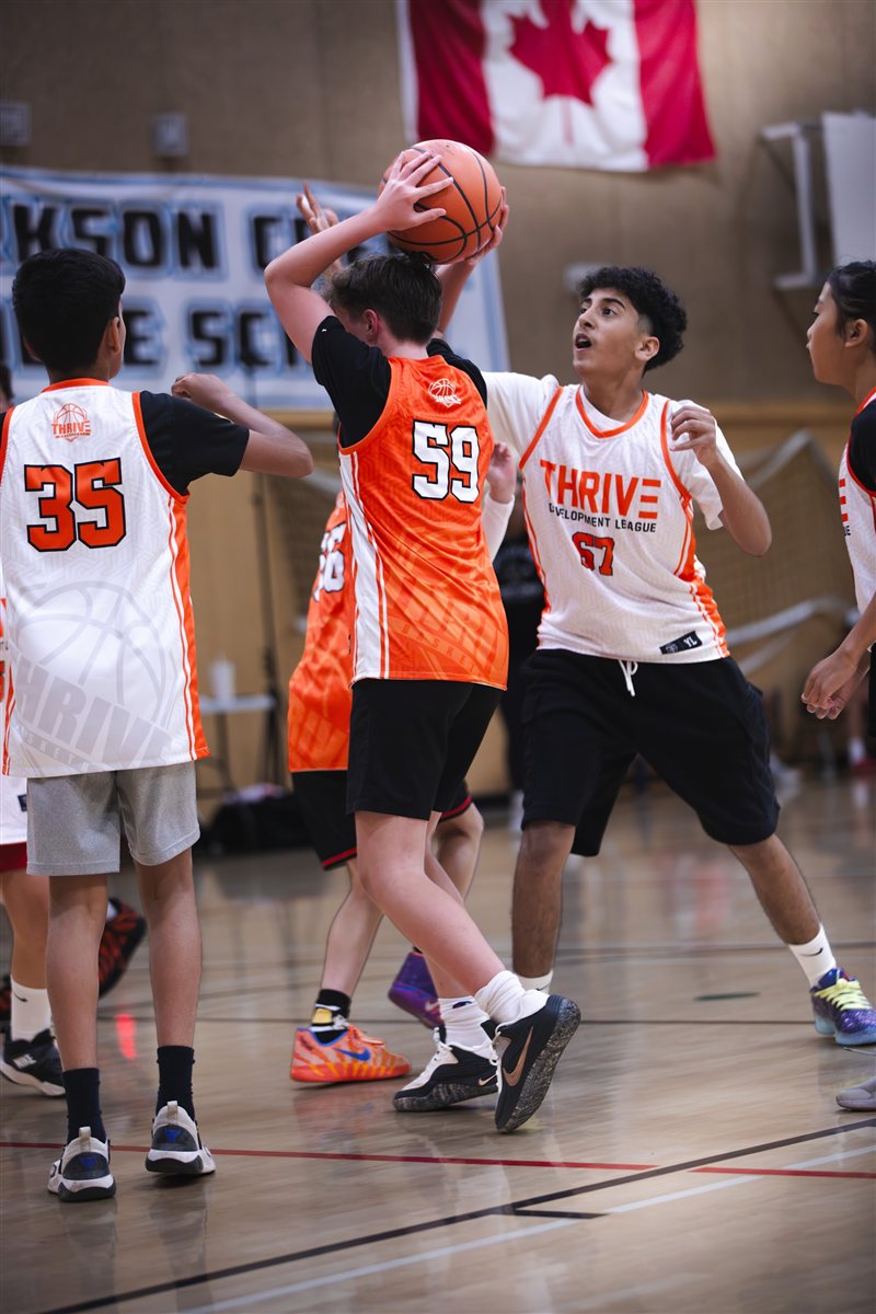 Basketball player shooting between defenders