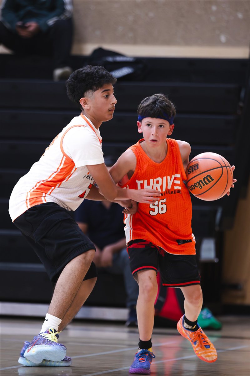 Basketball player dribbling past an opponent