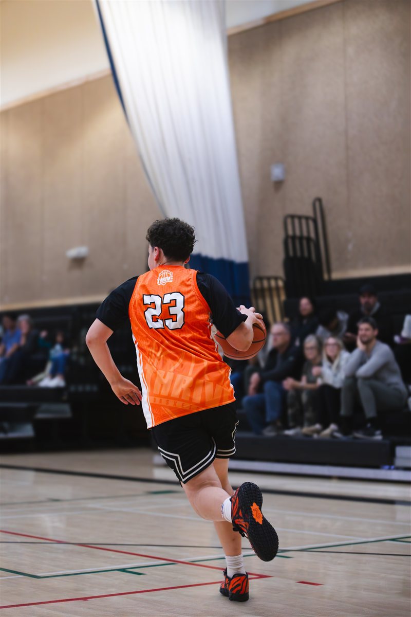 Basketball player running toward the basket