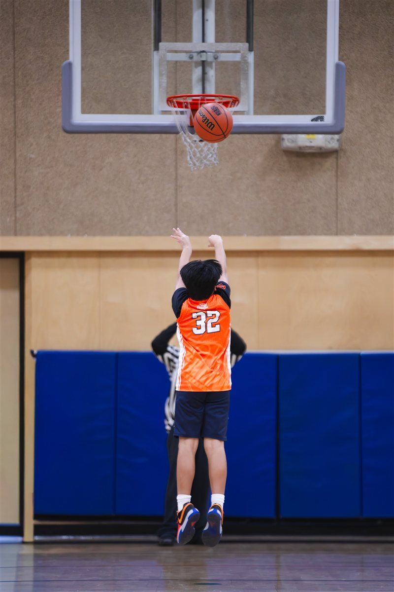 Basketball player jumping toward the hoop