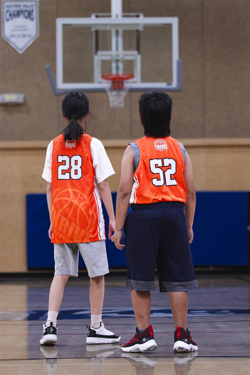 Basketball teammates watching the hoop